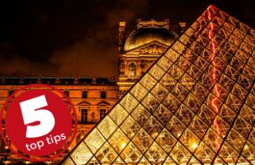 5 top tips for embracing culture. The Louvre museum and glass pyramid illuminated at night